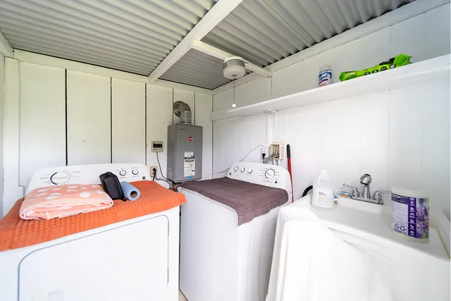 a bedroom with bed and a large window