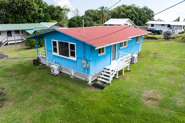 a aerial view of a house with a yard