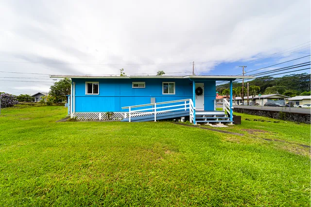 a front view of a house with garden