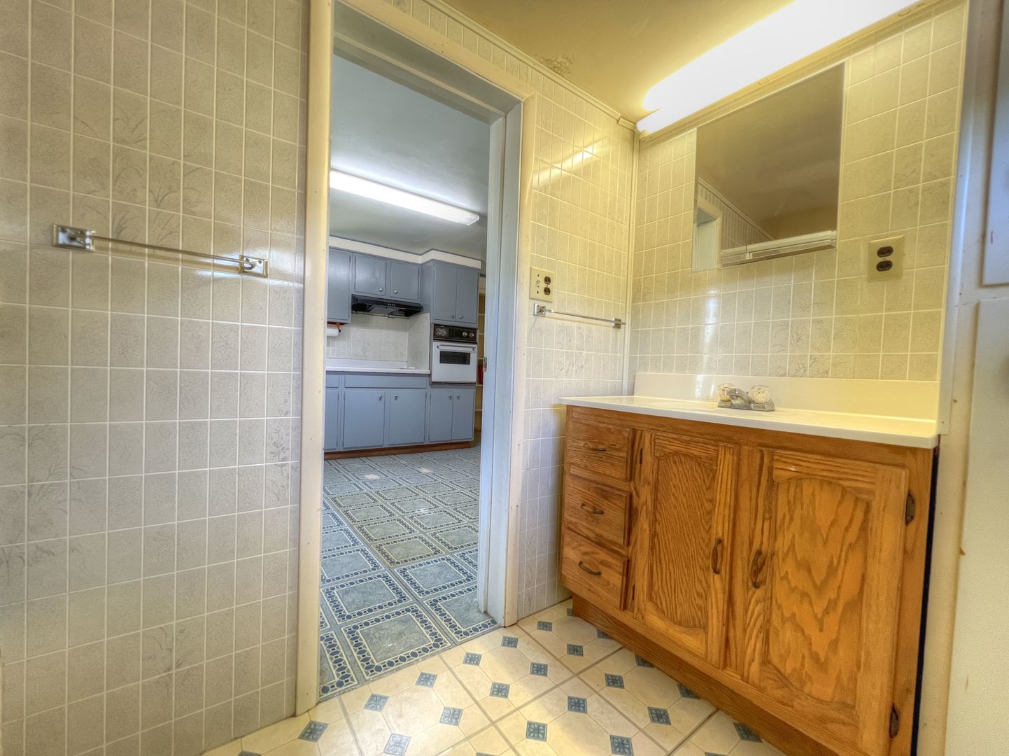 309 Jefferson Street Danforth, IL 60930 - Photo 21 of 45 a bathroom with a granite countertop sink a mirror and shower