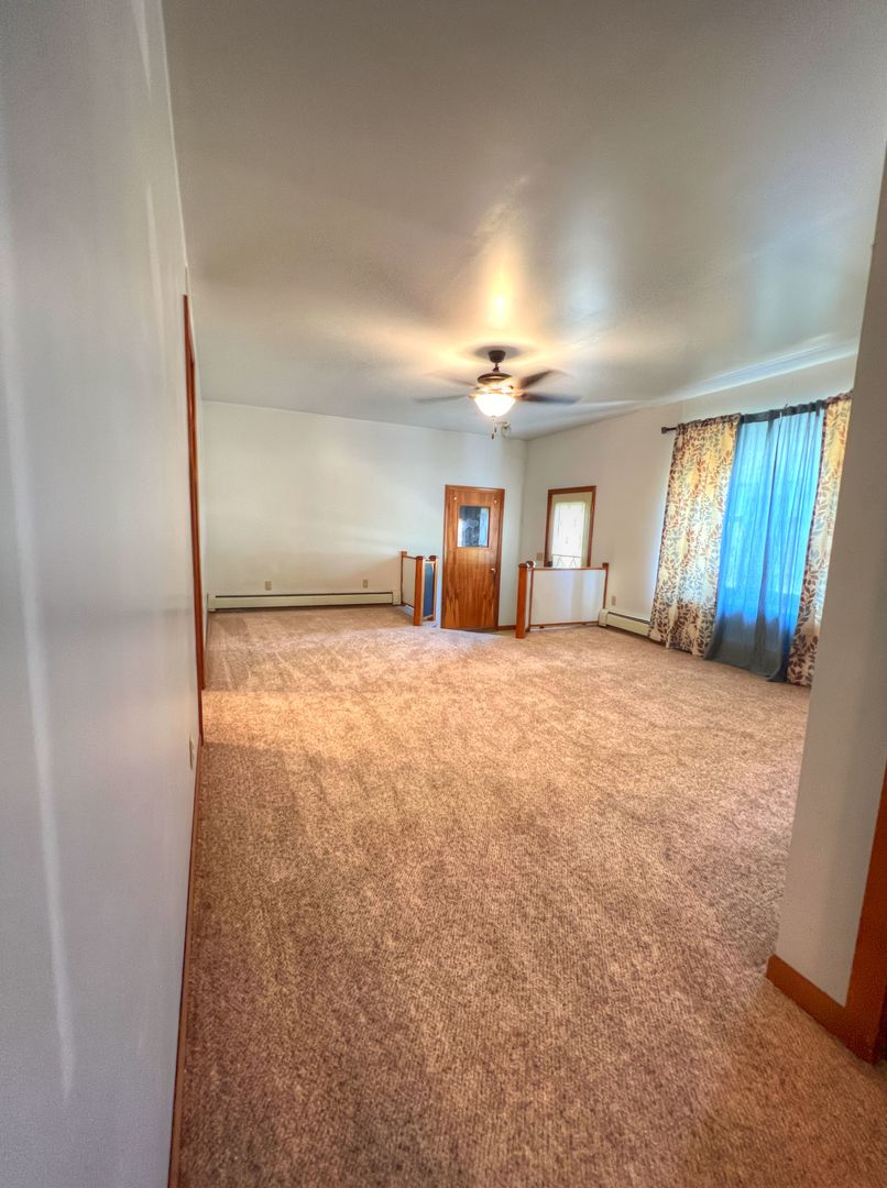 309 Jefferson Street Danforth, IL 60930 - Photo 28 of 45 an empty room with windows and chandelier fan