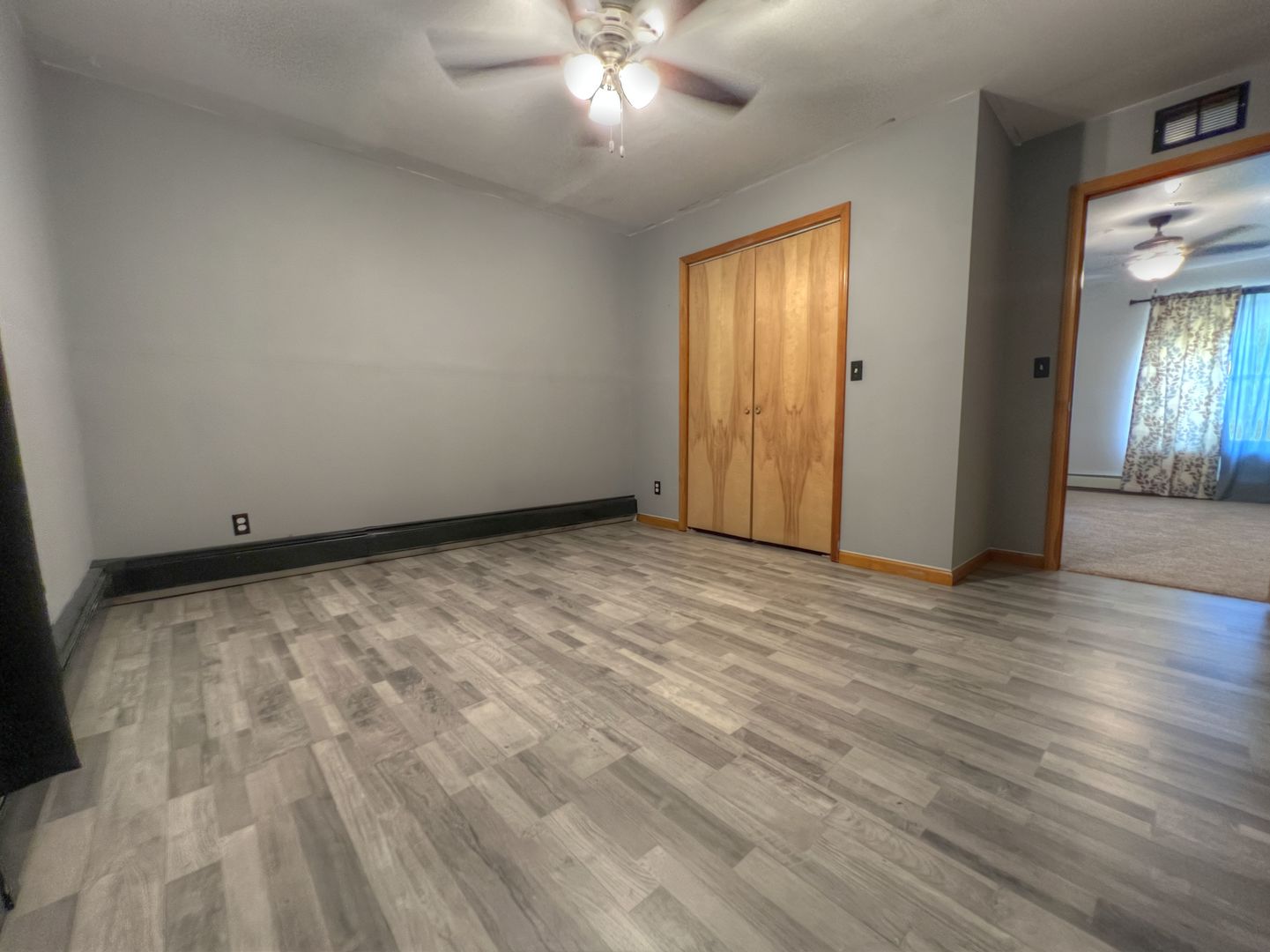 309 Jefferson Street Danforth, IL 60930 - Photo 36 of 45 a view of an empty room with wooden floor and a window