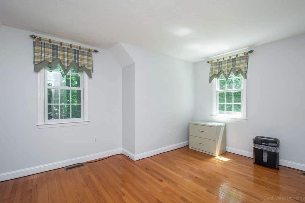 61 Coolidge Farm Road Boxborough, MA 01719 - Photo 29 of 39 a view of an empty room with wooden floor and a window