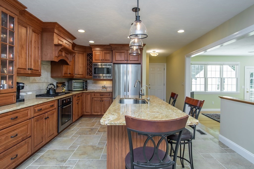61 Coolidge Farm Road Boxborough, MA 01719 - Photo 6 of 39 a large kitchen with a table and chairs