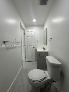 1084 Northwest 64th Street Miami, FL 33150 - Photo 11 of 12 a bathroom with a toilet sink and mirror