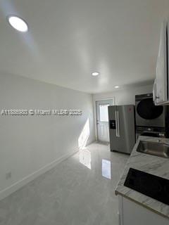 1084 Northwest 64th Street Miami, FL 33150 - Photo 6 of 12 a kitchen with stainless steel appliances granite countertop a sink and a stove