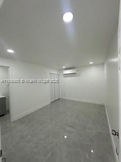 1084 Northwest 64th Street Miami, FL 33150 - Photo 7 of 12 an empty room with wall dryer and refrigerator