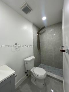 1084 Northwest 64th Street Miami, FL 33150 - Photo 10 of 12 a bathroom with a toilet a sink and shower