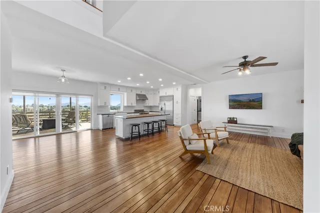 a bathroom with a granite countertop sink a toilet a large mirror and shower