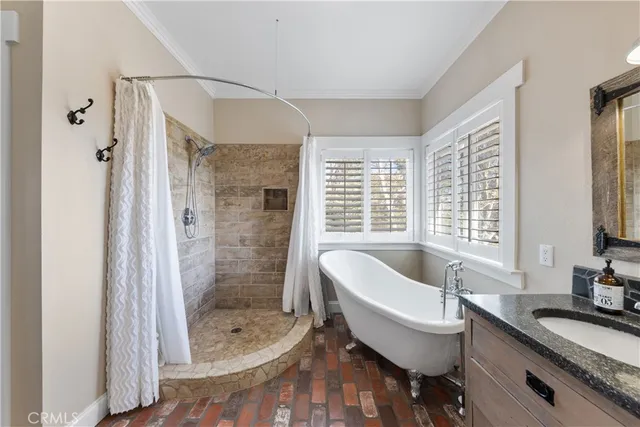 a kitchen with granite countertop stainless steel appliances a refrigerator a sink and cabinets