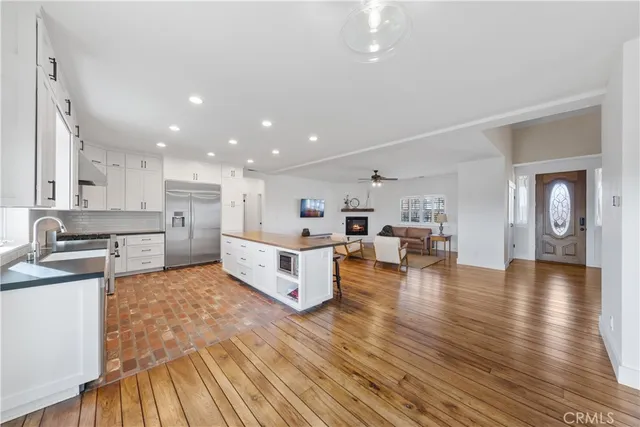 a dining room with furniture a rug and wooden floor