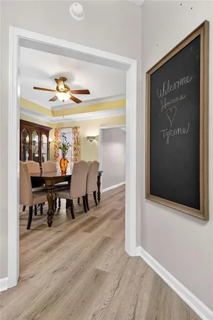 a kitchen with stainless steel appliances granite countertop a refrigerator a sink dishwasher a stove and white cabinets with wooden floor