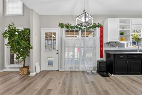 a view of a livingroom with a fireplace a ceiling fan and windows