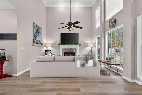 a living room with furniture a flat screen tv and a fireplace