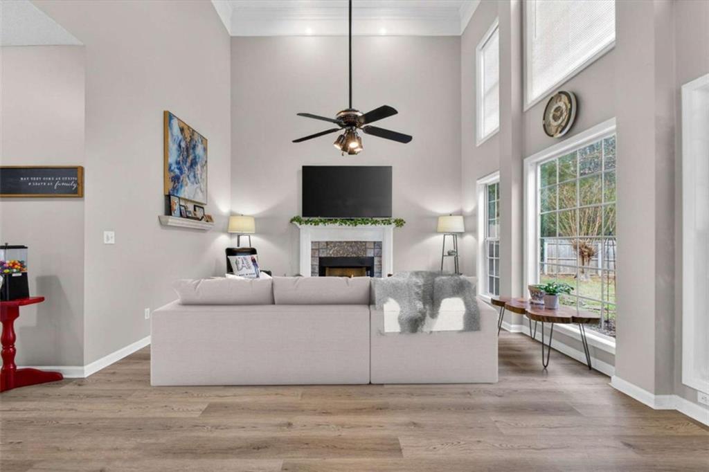 230 Gaelic Way Tyrone, GA 30290 - Photo 21 of 53 a living room with furniture a fireplace and a flat screen tv