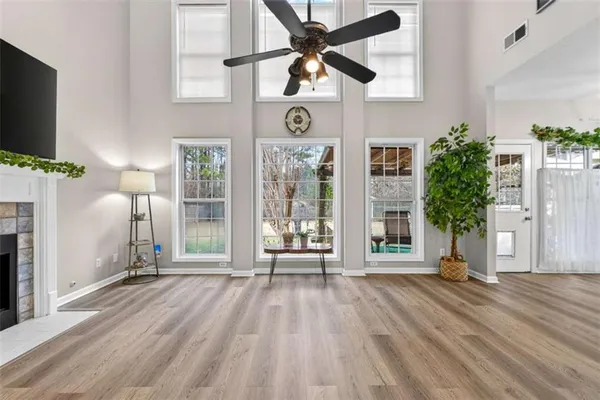 a view of an empty room with a fireplace and a window