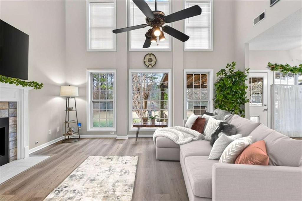 230 Gaelic Way Tyrone, GA 30290 - Photo 23 of 53 a living room with furniture a flat screen tv and a fireplace