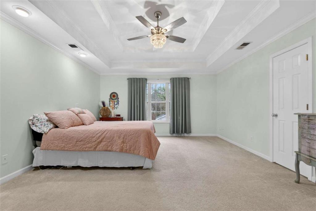 230 Gaelic Way Tyrone, GA 30290 - Photo 30 of 53 a spacious bedroom with a bed and a ceiling fan