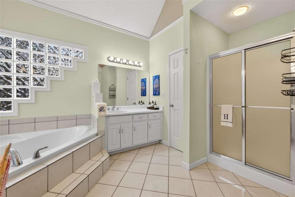 230 Gaelic Way Tyrone, GA 30290 - Photo 34 of 53 a bathroom with a bathtub sink and a mirror