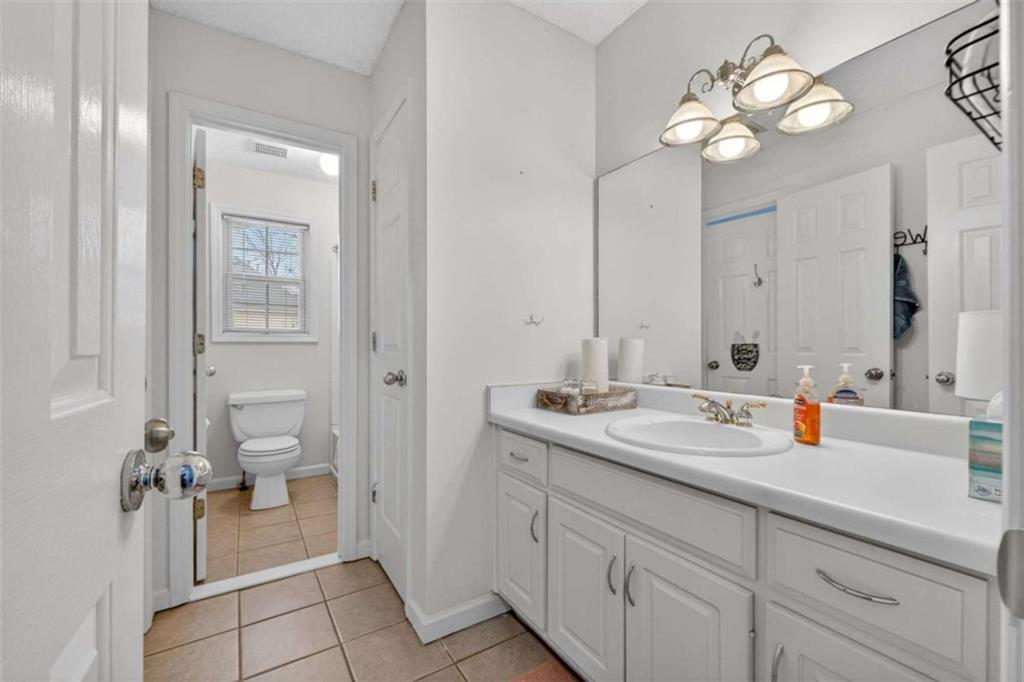 230 Gaelic Way Tyrone, GA 30290 - Photo 38 of 53 a bathroom with a sink a toilet and a mirror