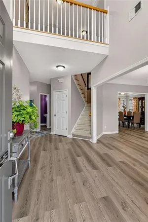 a view of an entryway with wooden floor
