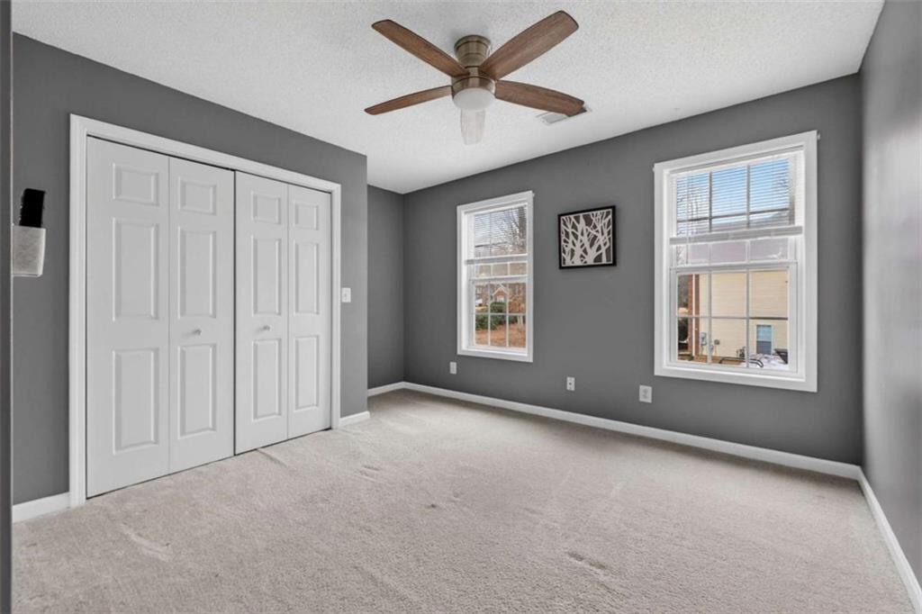 230 Gaelic Way Tyrone, GA 30290 - Photo 41 of 53 an empty room with windows and fan