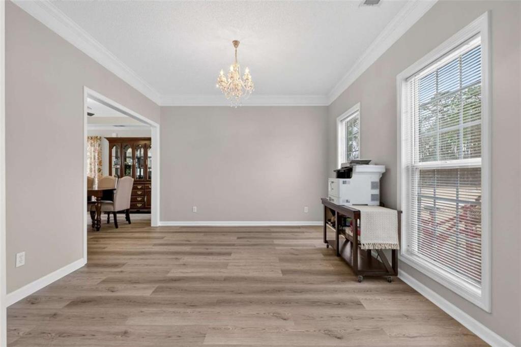 230 Gaelic Way Tyrone, GA 30290 - Photo 9 of 53 a view of an empty room with a window and wooden floor