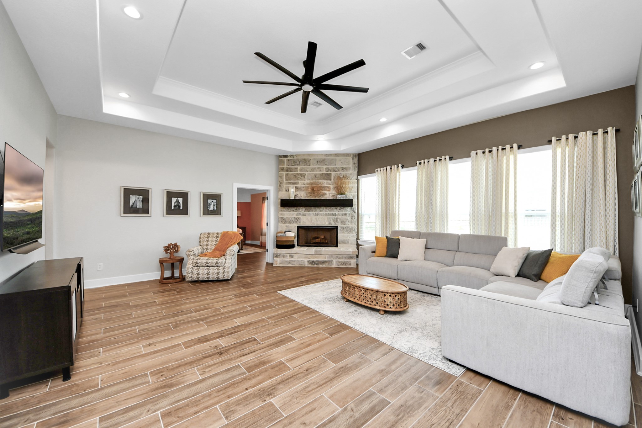 7723 Stratford Hall Drive Rosharon, TX 77583 - Photo 21 of 50 a living room with furniture a fireplace and a flat screen tv
