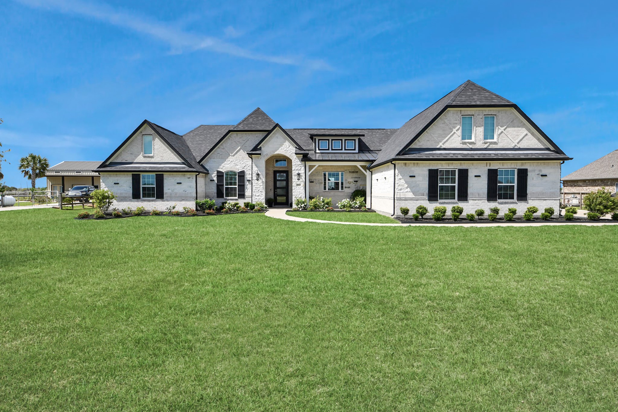7723 Stratford Hall Drive Rosharon, TX 77583 - Photo 5 of 50 a front view of a house with a garden and trees