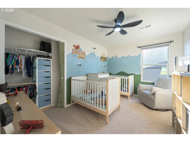 a bedroom with furniture and a ceiling fan