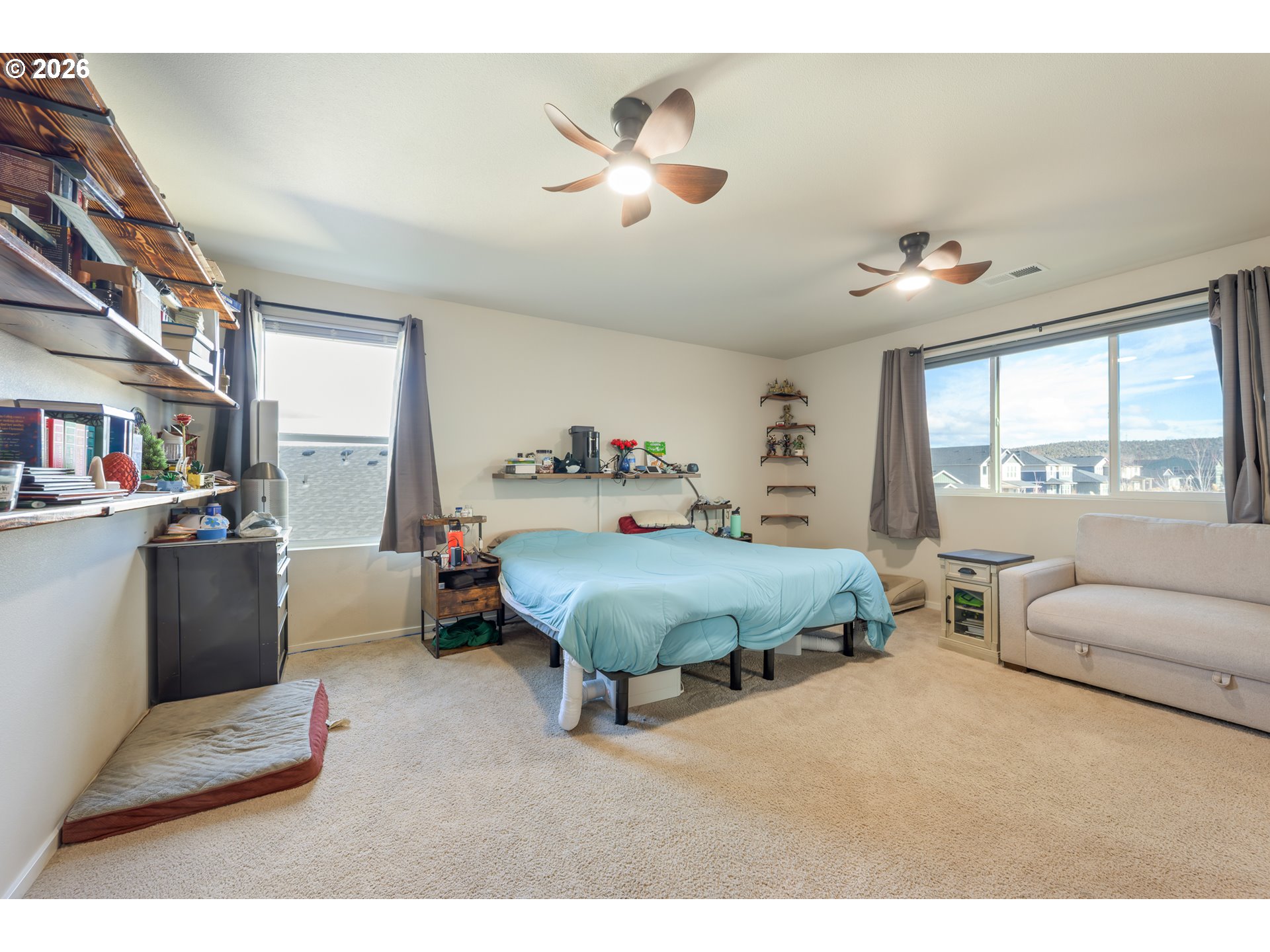 641 Northeast Union Loop Prineville, OR 97754 - Photo 16 of 23 a spacious bedroom with a bed a couch and a large window
