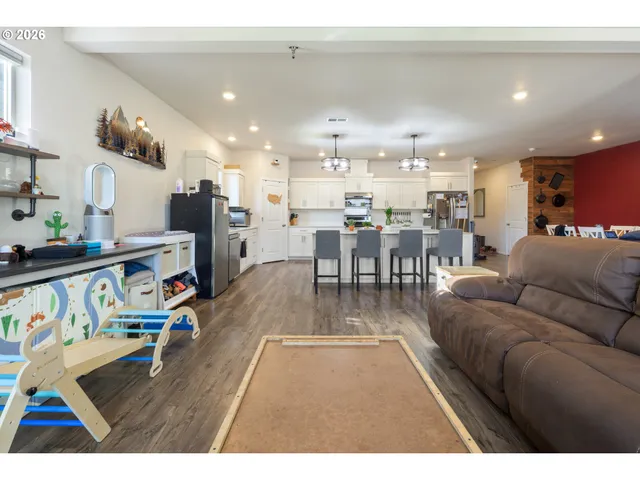 a living room with lots of furniture and kitchen view
