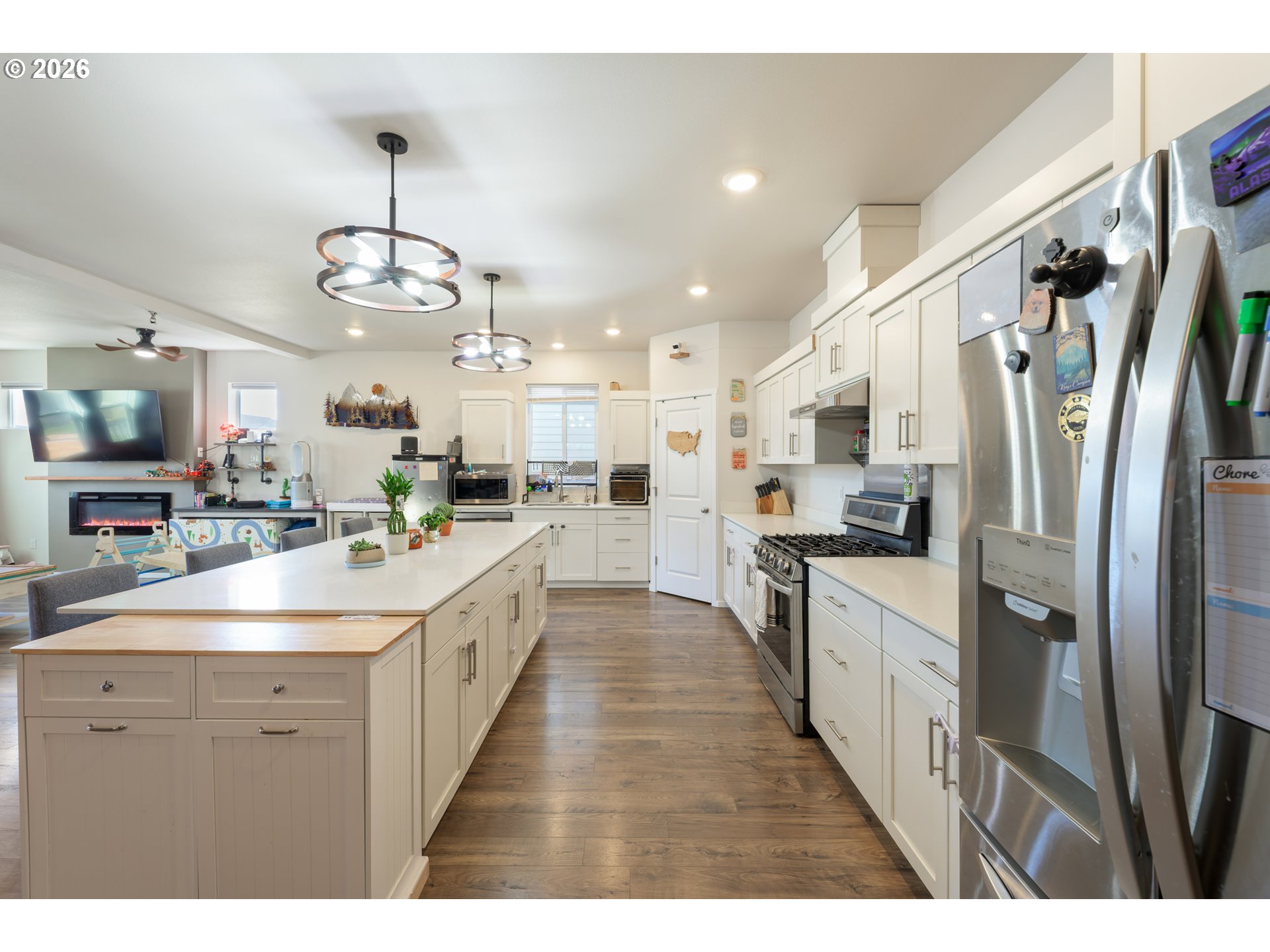 641 Northeast Union Loop Prineville, OR 97754 - Photo 6 of 23 a large kitchen with stainless steel appliances kitchen island granite countertop a refrigerator a stove a sink dishwasher and white cabinets with wooden floor