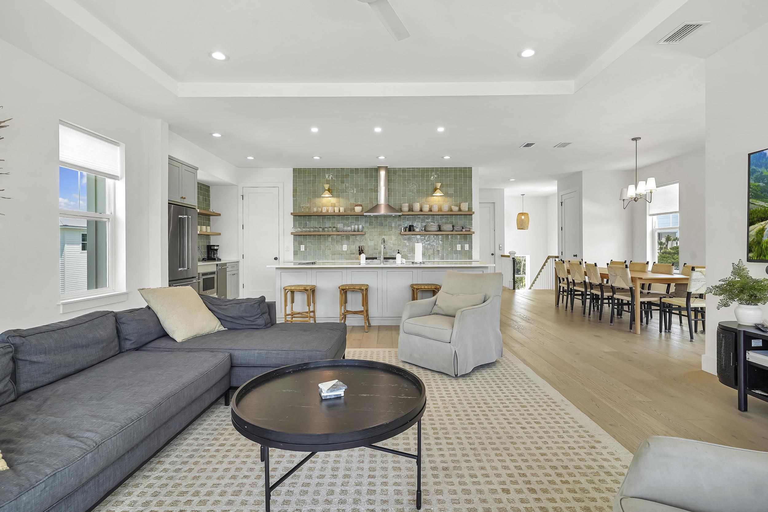 104 7th Street St. Augustine, FL 32080 - Photo 13 of 59 Living room with healthy amount of natural light, light wood-type flooring, a raised ceiling, and a chandelier