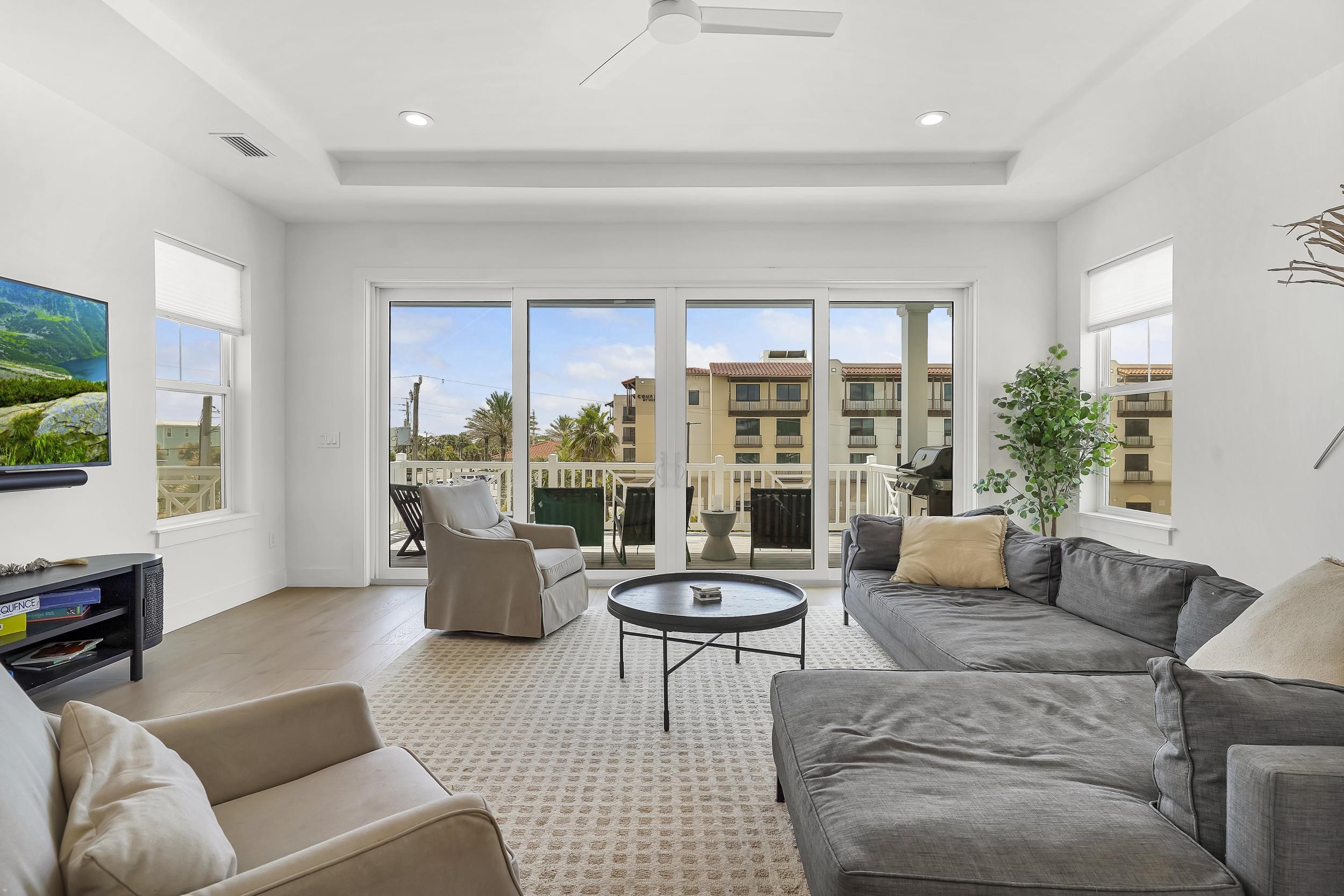104 7th Street St. Augustine, FL 32080 - Photo 15 of 59 Living room featuring wood finished floors, a ceiling fan, a tray ceiling, and recessed lighting