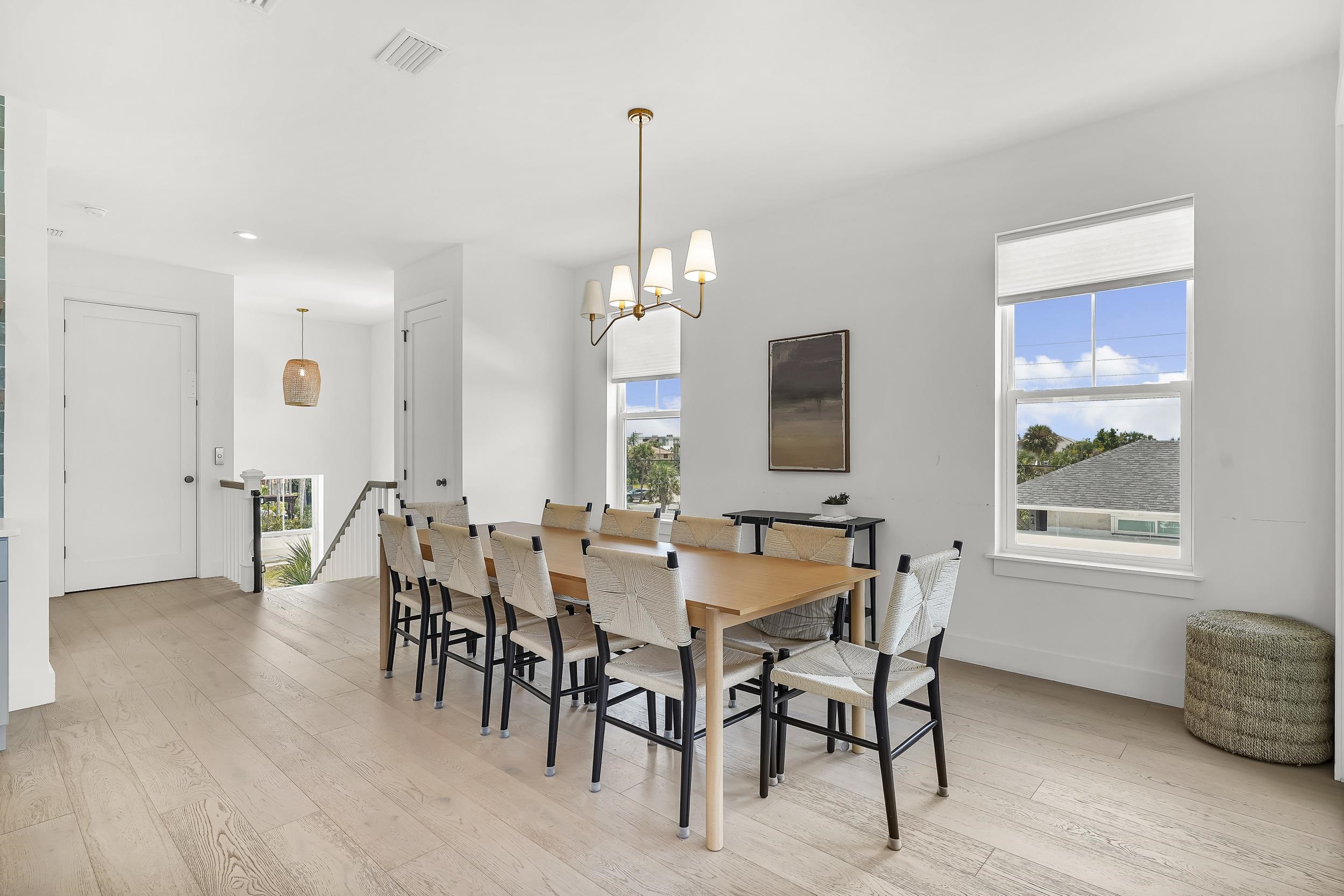 104 7th Street St. Augustine, FL 32080 - Photo 17 of 59 Dining space featuring light wood finished floors, plenty of natural light, and a chandelier