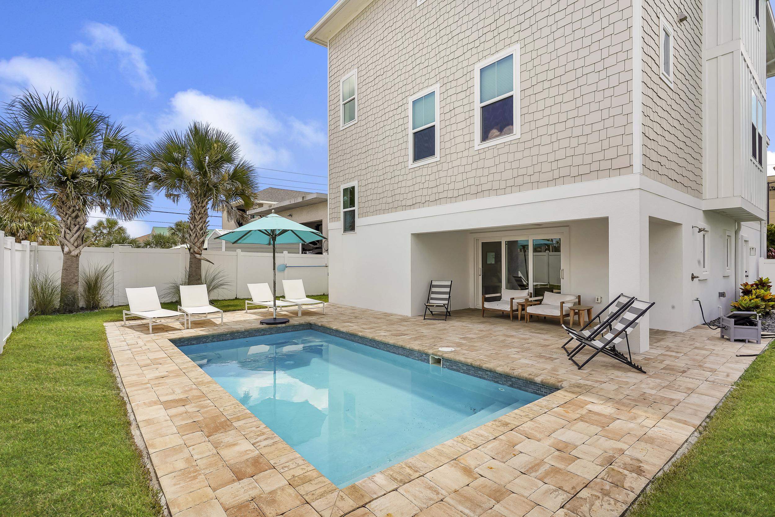 104 7th Street St. Augustine, FL 32080 - Photo 2 of 59 Back of property with a fenced backyard, a patio area, and stucco siding