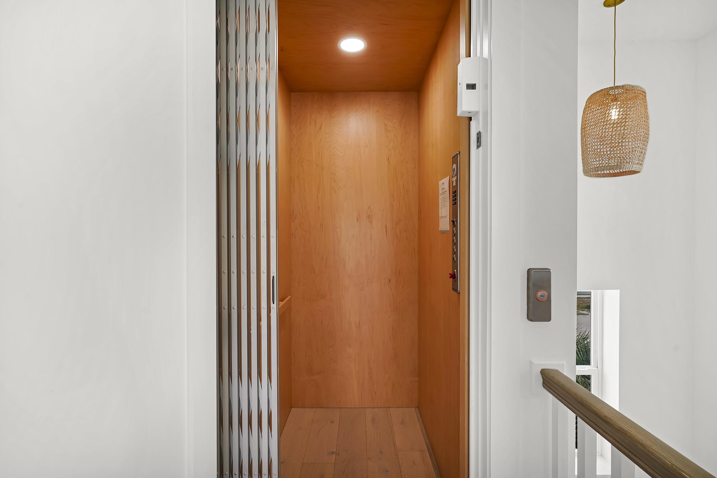 104 7th Street St. Augustine, FL 32080 - Photo 21 of 59 Elevator with recessed lighting, wood finished floors, and wood walls