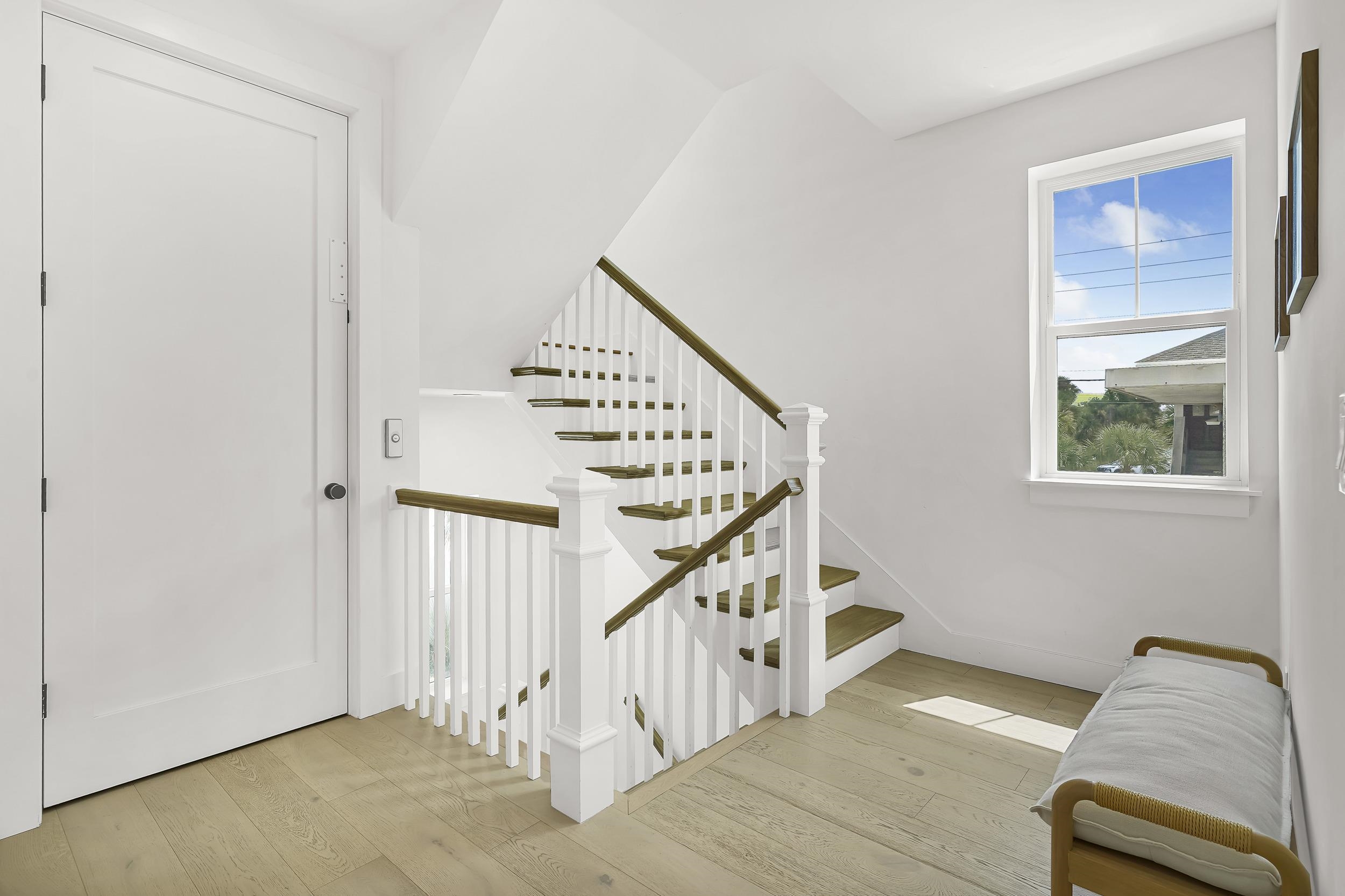 104 7th Street St. Augustine, FL 32080 - Photo 29 of 59 Stairs featuring hardwood / wood-style flooring
