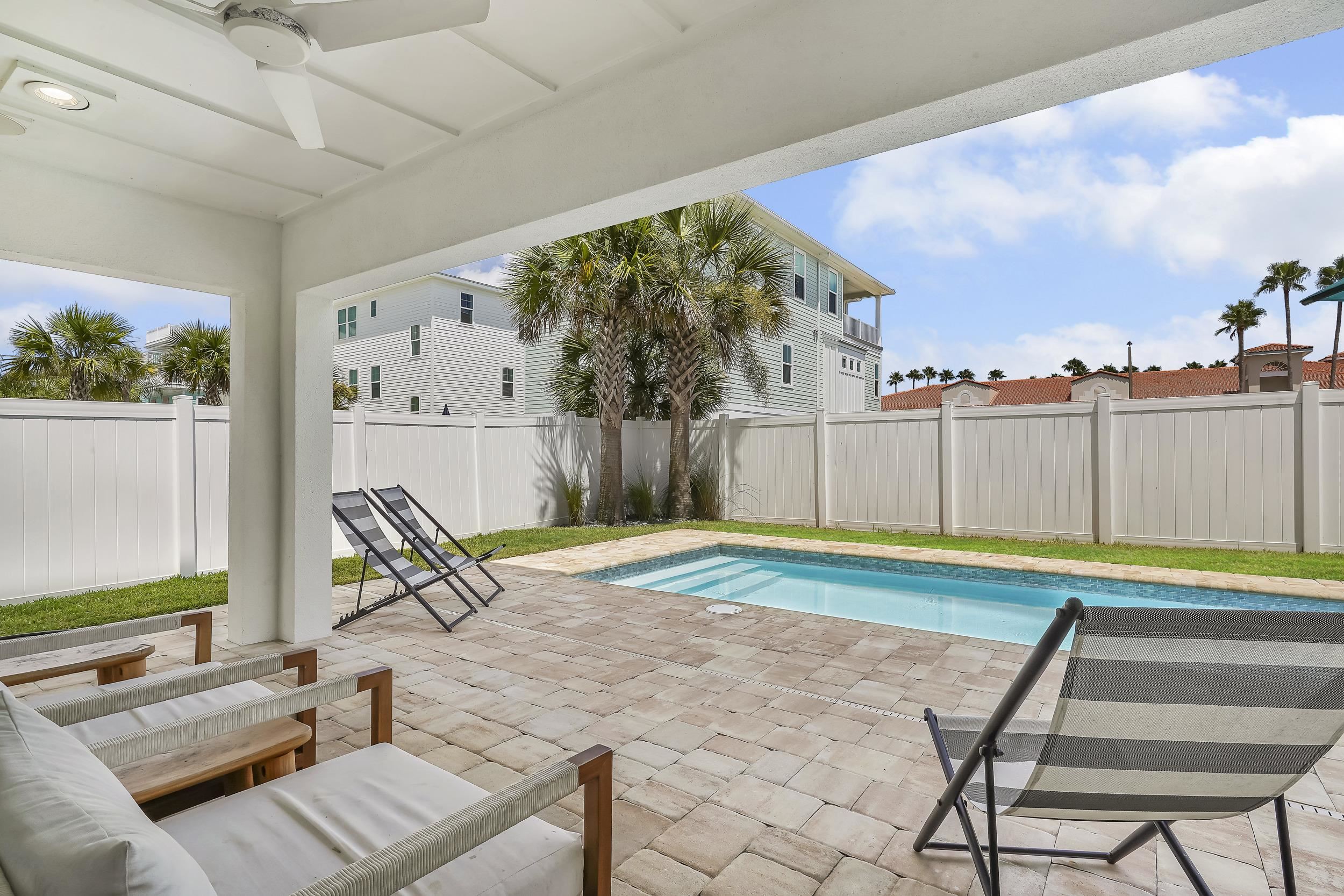 104 7th Street St. Augustine, FL 32080 - Photo 3 of 59 View of swimming pool featuring patio surround and a fenced backyard