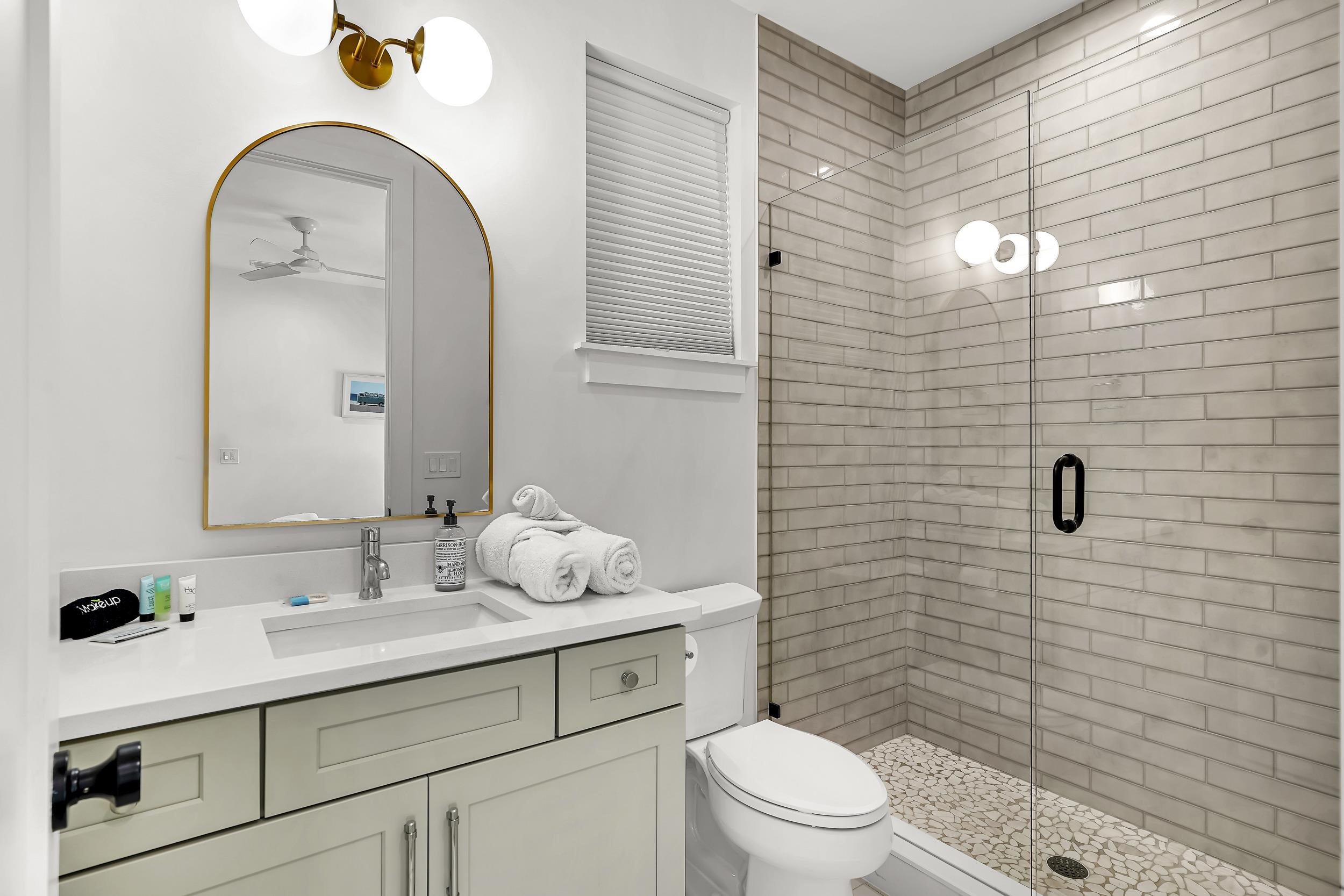 104 7th Street St. Augustine, FL 32080 - Photo 32 of 59 Bathroom with vanity, a stall shower, and a ceiling fan