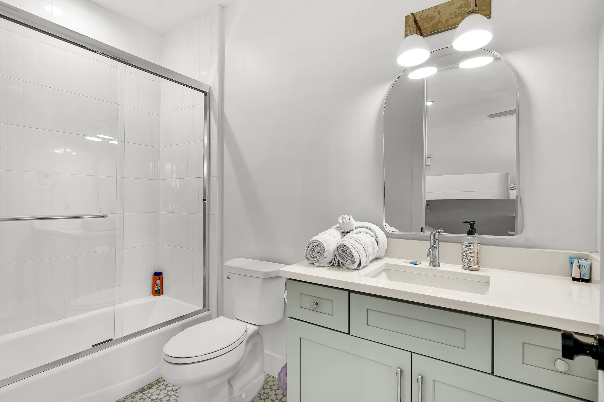 104 7th Street St. Augustine, FL 32080 - Photo 36 of 59 Full bathroom with vanity and bath / shower combo with glass door