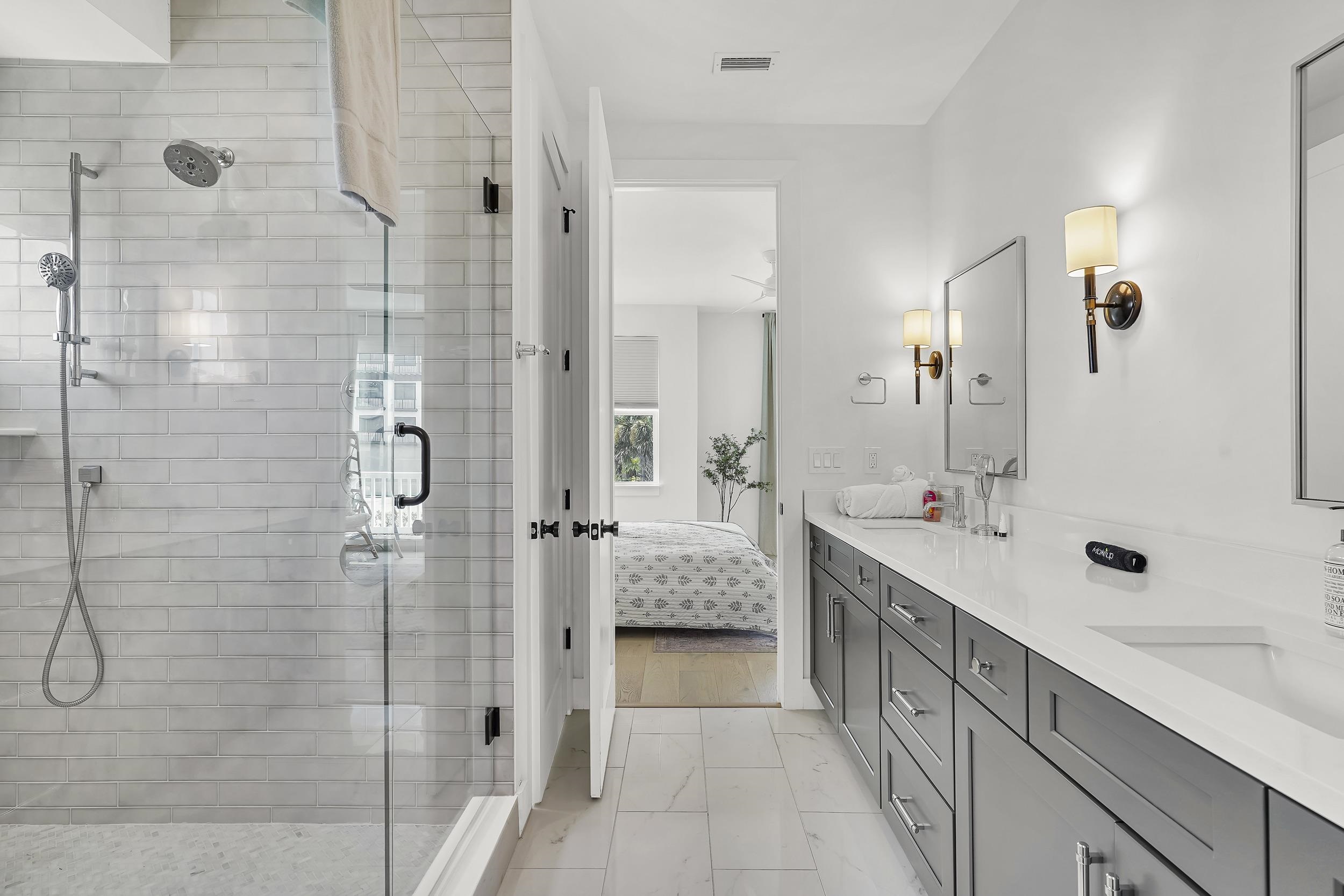 104 7th Street St. Augustine, FL 32080 - Photo 42 of 59 Full bath featuring double vanity, a stall shower, and ensuite bathroom