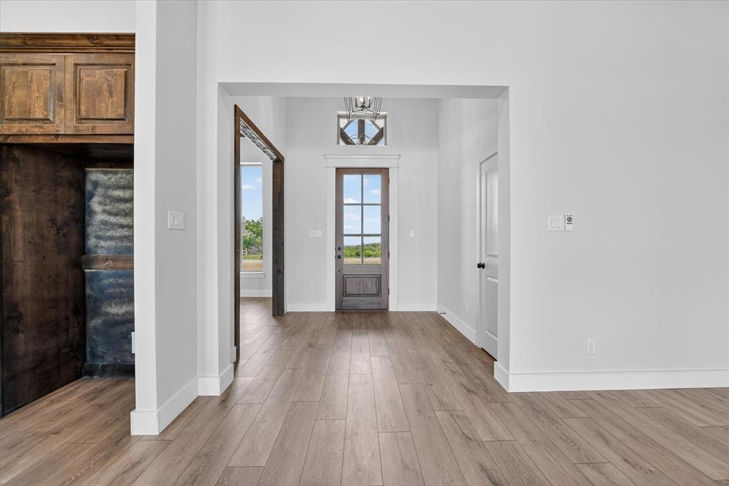 517 Longhorn Lane Springtown, TX 76082 - Photo 5 of 39 Foyer with light wood-style flooring and hanging lights