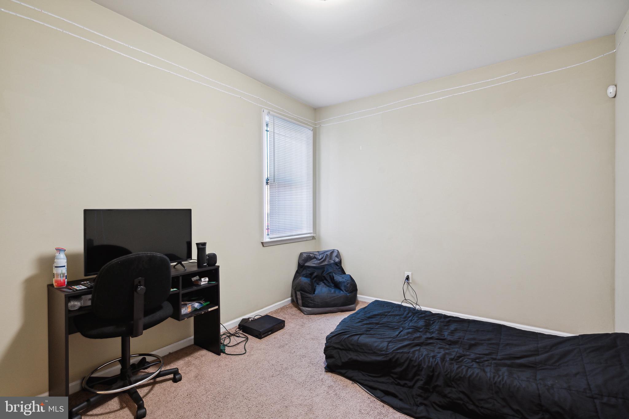 1611 North 17th Street, Unit 2 Philadelphia, PA 19121 - Photo 15 of 18 a bedroom with a bed and a computer on a desk