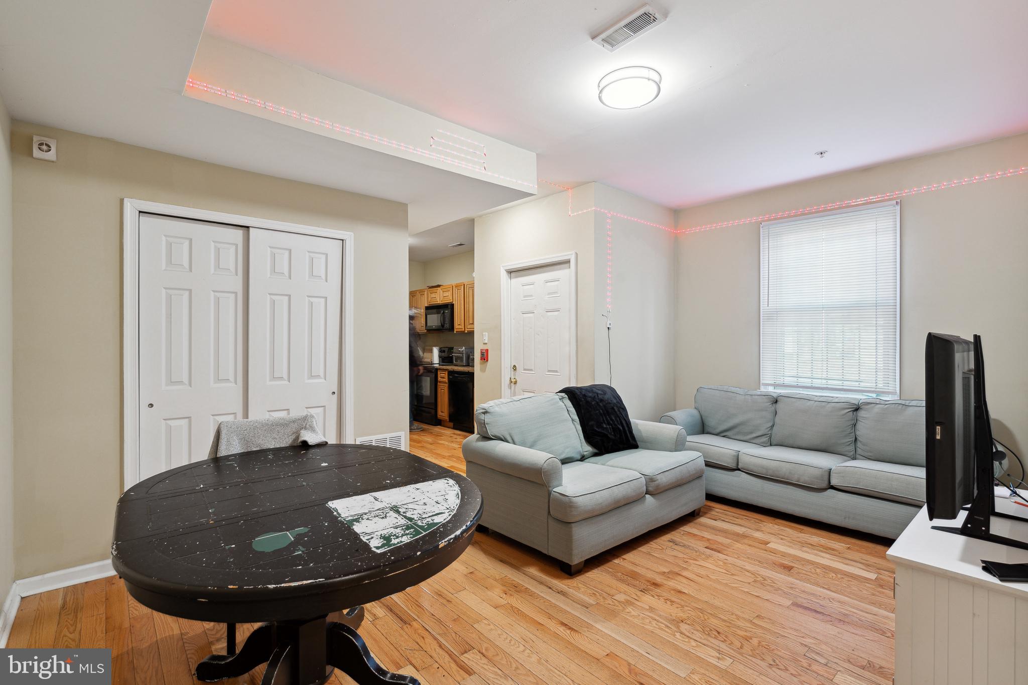 1611 North 17th Street, Unit 2 Philadelphia, PA 19121 - Photo 3 of 18 a living room with furniture and a window