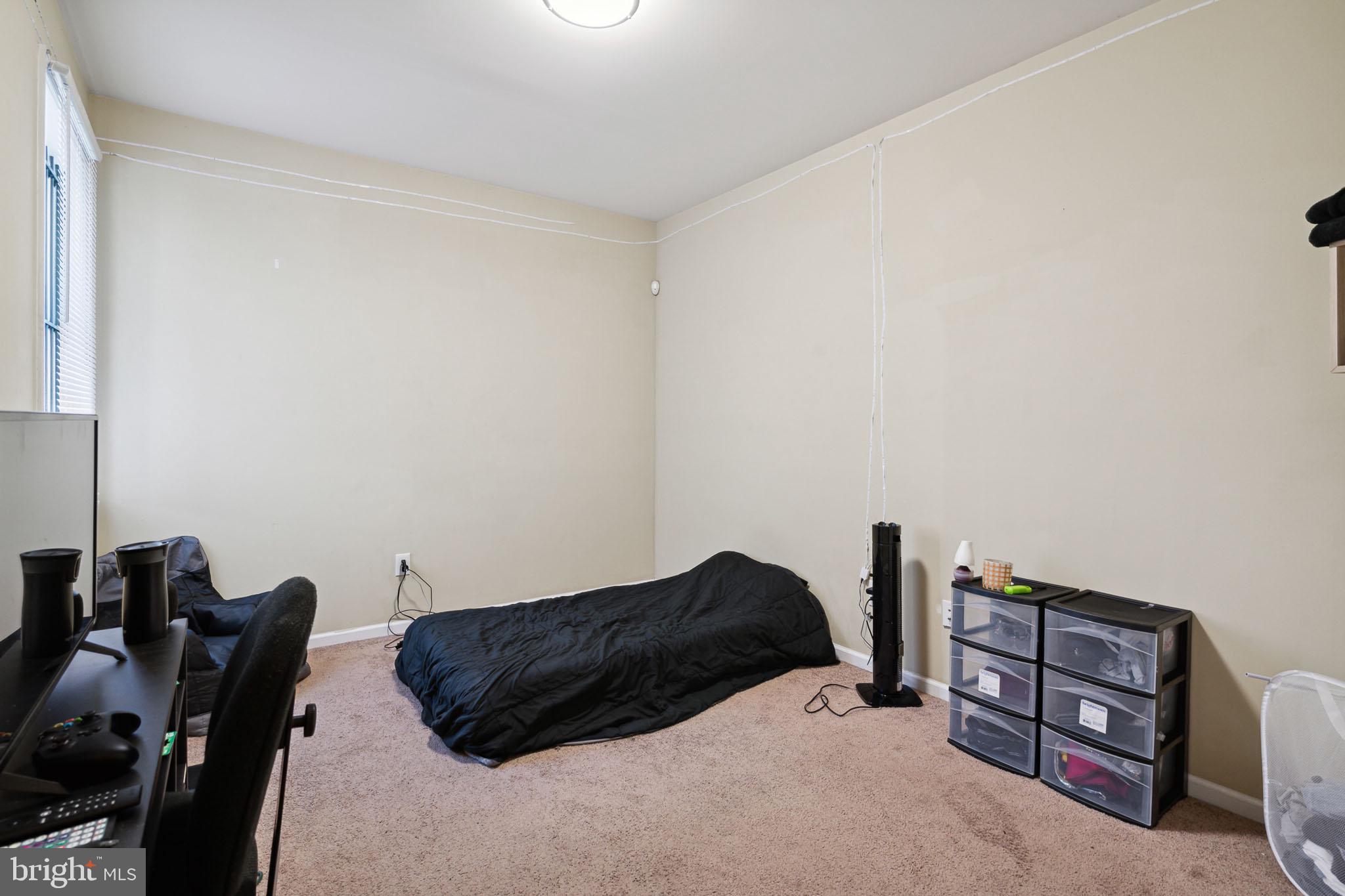 1611 North 17th Street, Unit 2 Philadelphia, PA 19121 - Photo 7 of 18 a bedroom with a bed and a dresser