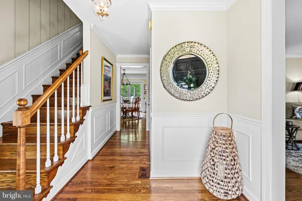 a view of a hallway with entryway wooden floor and front door