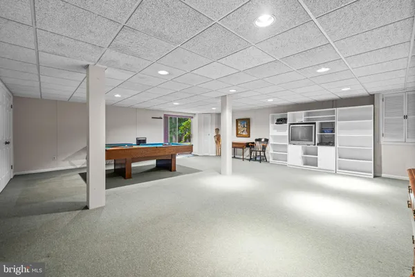 a living room with furniture pool table and a table