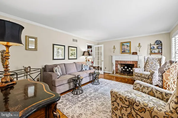 a living room with furniture a fireplace and a table